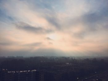 Cloudy sky above city at sunset