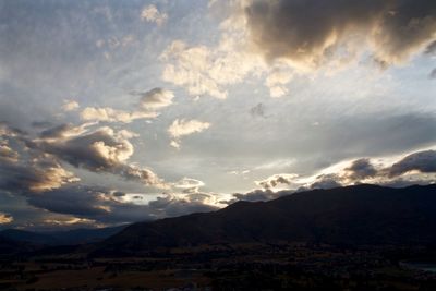 Scenic view of mountains against cloudy sky