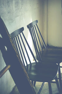 Empty chairs and table against wall at home