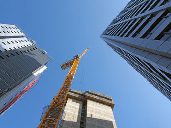 Low angle view of modern building against clear blue sky