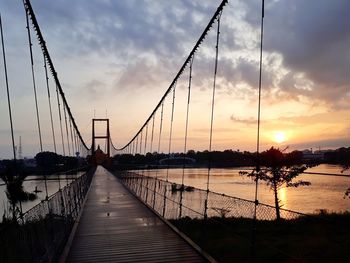 Silhouette bridge against sky during sunset