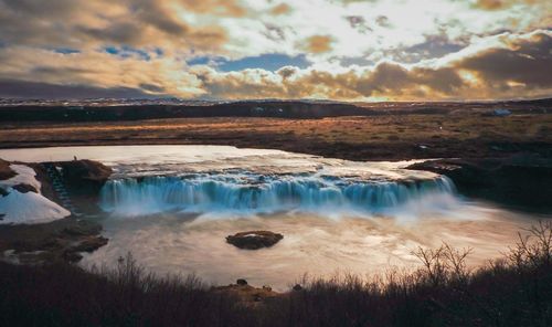 Scenic view of sea against cloudy sky