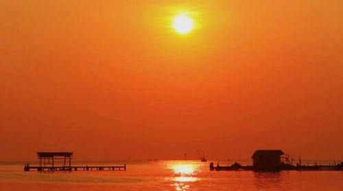 Scenic view of sea against orange sky during sunset