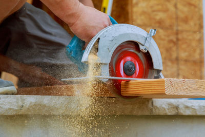 Close-up of man working on wood