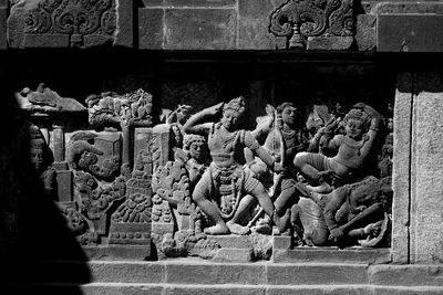 Sculpture of statues outside building