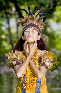 Teenage girl wearing traditional clothing in forest