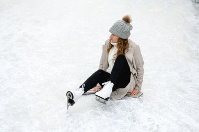 Portrait of woman standing on snow covered field