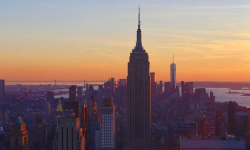 Buildings in city during sunset