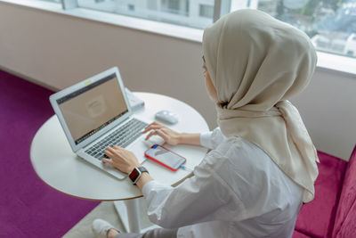 Side view of woman using mobile phone