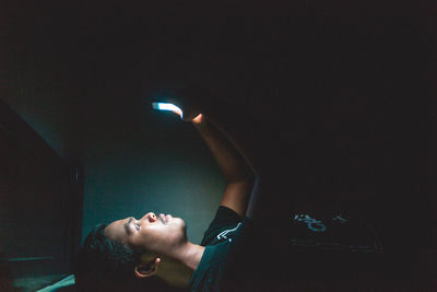 Reflection of man on illuminated light painting