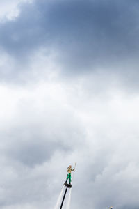 Low angle view of cross against sky