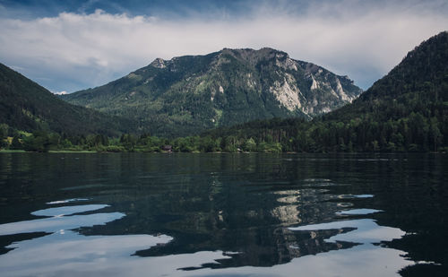 Scenic view of lake and mountains against sky