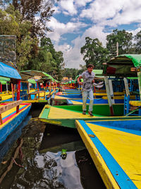 People on boat against canal