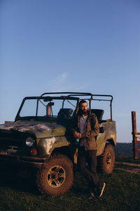 Portrait of man on field against clear sky