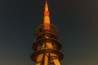 Low angle view of illuminated building against sky at night