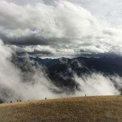 Scenic view of mountains against cloudy sky