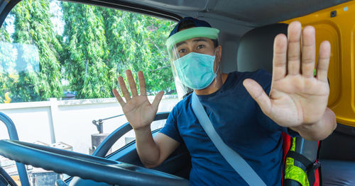 Portrait of man sitting in car window