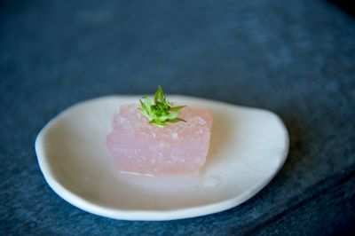 Close-up of gelatin dessert garnished with flower in plate on table