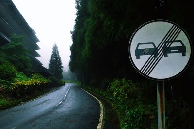 Road sign by trees
