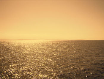 Scenic view of sea against clear sky during sunset