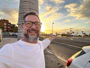 Portrait of man standing against sky during sunset