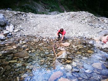 High angle view of man standing on rock