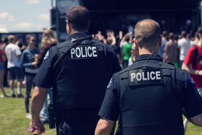 Rear view of police force at park