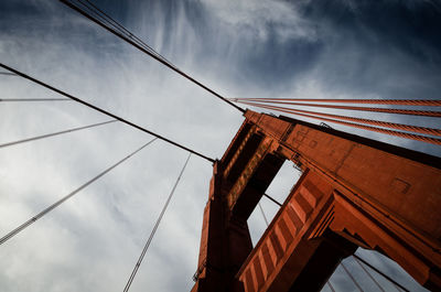 Low angle view of bridge against cloudy sky