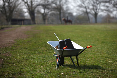 Empty chairs on grass in park