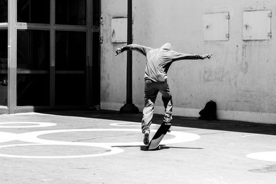 Full length of man skateboarding on wall