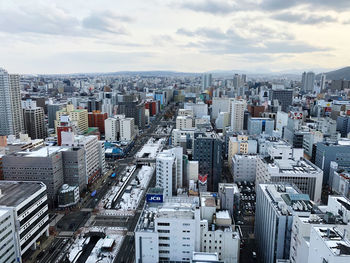 High angle view of modern buildings in city against sky