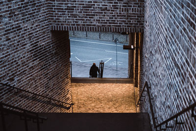 High angle view of man moving down on steps in city