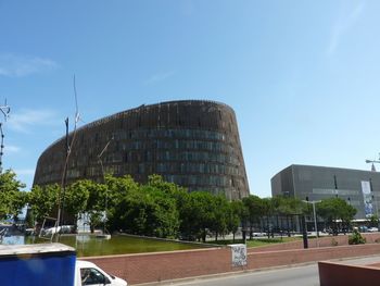 Buildings in city against blue sky