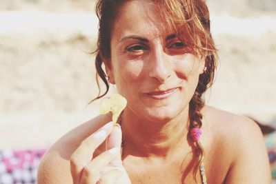 Close-up portrait of young woman at beach