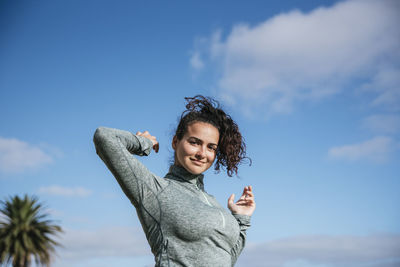 Woman smiling with the blue sky.