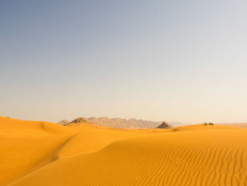 Scenic view of desert against blue sky