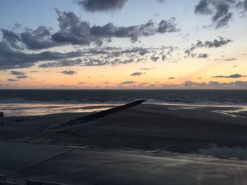 Scenic view of beach against sky during sunset