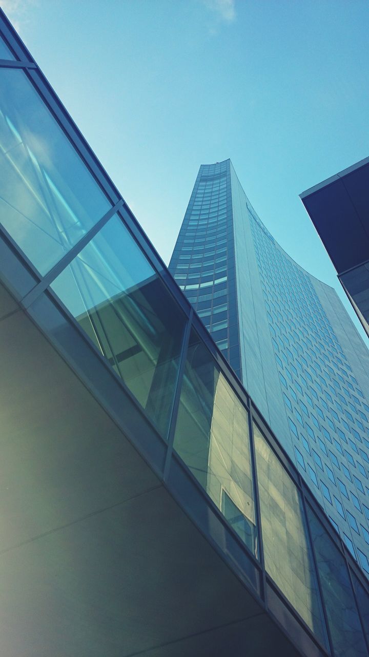 architecture, building exterior, built structure, modern, low angle view, office building, city, skyscraper, glass - material, tall - high, reflection, building, tower, sky, window, clear sky, day, blue, glass, no people