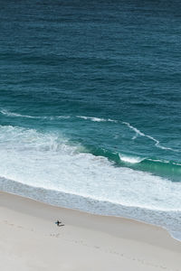 Aerial view of surfer on beach