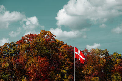 Low angle view of flag against blue sky