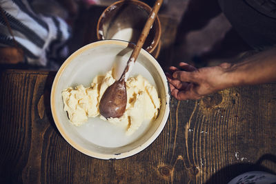 Female making butter with butter churn. old traditional method making of butter