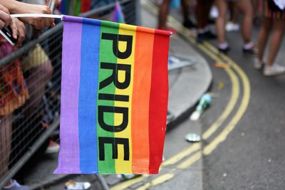 Close-up of rainbow flag with pride text in city