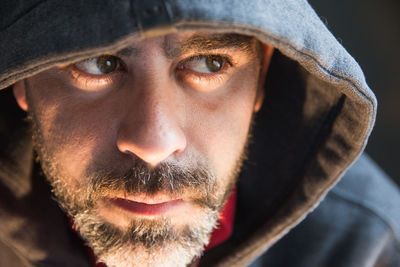 Close up of bearded man wearing hood jacket