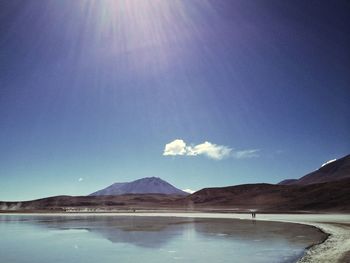 Scenic view of mountains against blue sky