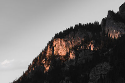 Low angle view of rocks on mountain against sky