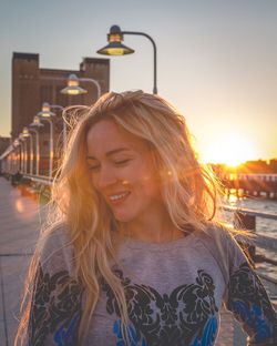 Portrait of young woman looking at city