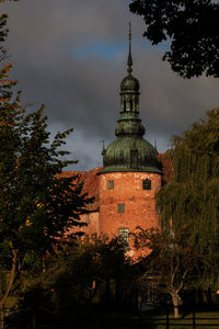 Low angle view of tower against cloudy sky