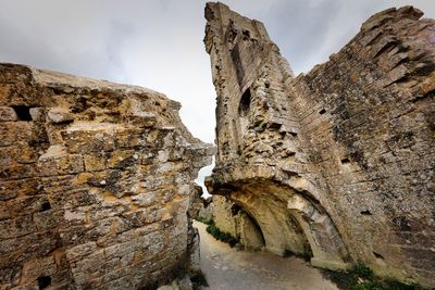 Low angle view of rock formation against sky