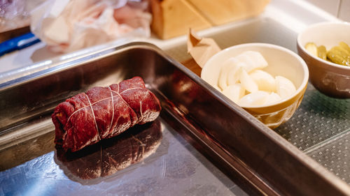 Close-up of prepared beef roulade in casserole dish on table