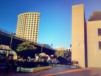 View of buildings against clear blue sky